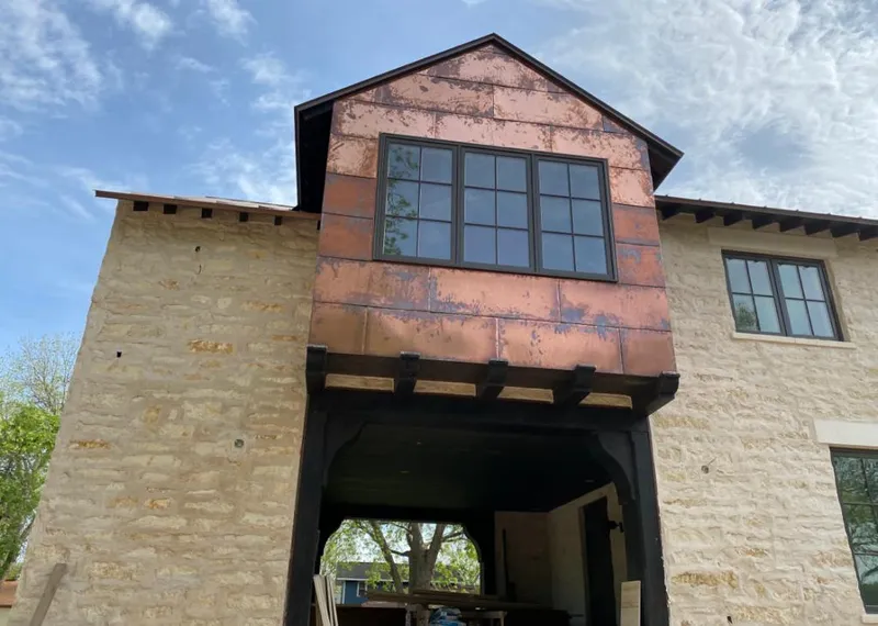 Copper metal panel facade on a stone building for Skylight Installation in Hardyston